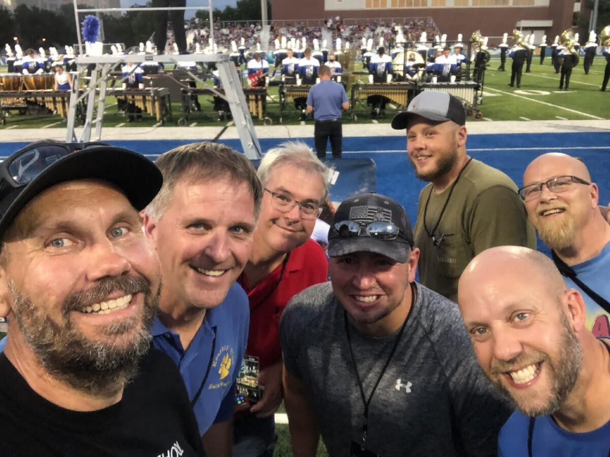 Pit Crew volunteers before football halftime performance