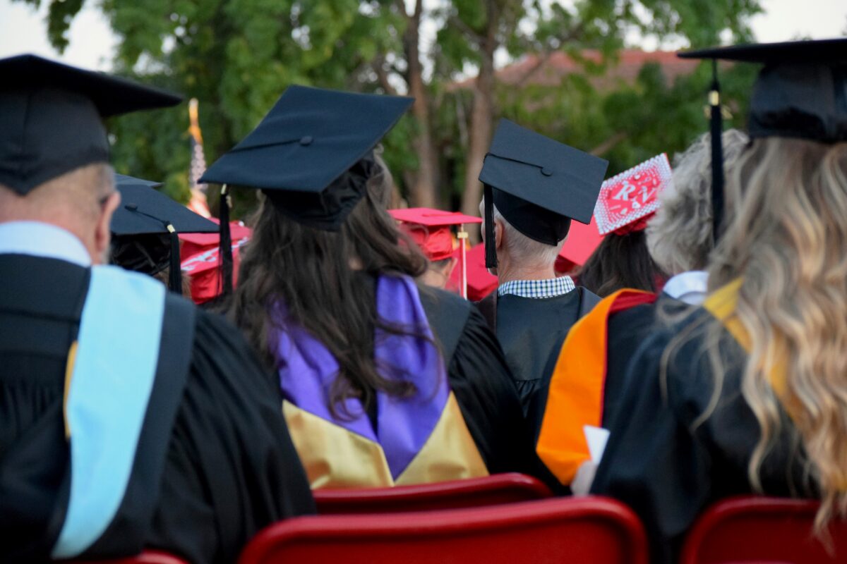 Graduates sitting in chairs at a ceremony